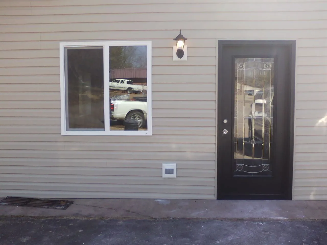 New siding, window and entry door on the side of an addition in Pollock Pines