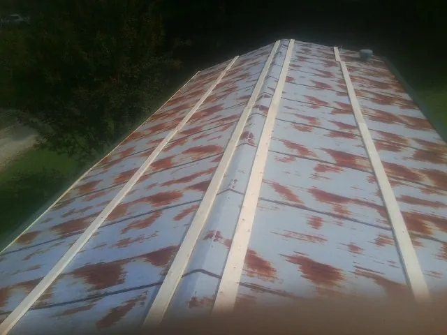 Rusted metal roof panels with new wood purlins before replacement — Storm Damage Roof Repair in Pollock Pines by Roofing Brothers